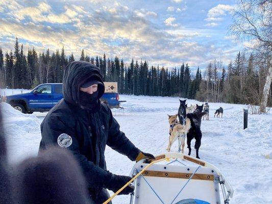 Matt, our musher, and the doggos ready to go!