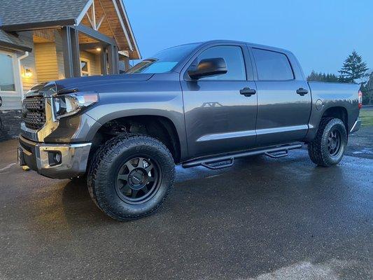 Leveling kit, wheels, tires and nerf bars.