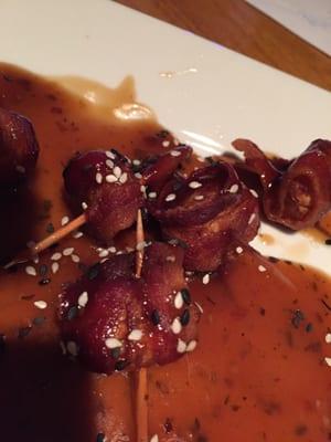 Bacon wrapped chestnuts with sesame seeds.