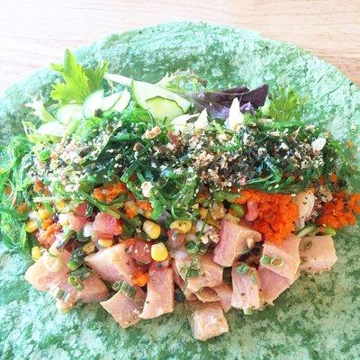 Loading up the poke wrap with your favorite base, proteins, toppings and sauces!