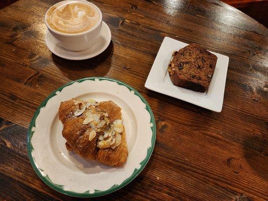 Latte, almond croissant, and banana bread