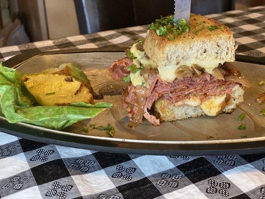 One half sandwich of Homemade combo of pastrami and corned beef with mustard and cheese. A throwback to the old fashioned.