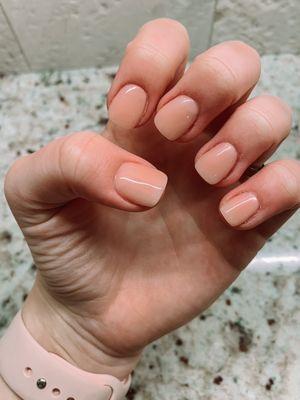 peach colored acrylic with a short tip and gel top coat