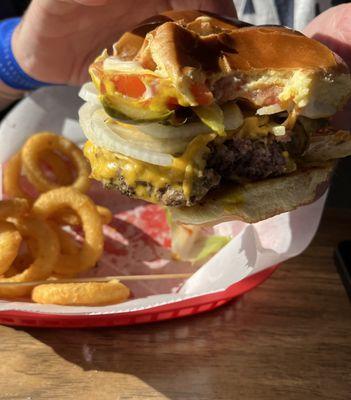 Single cheeseburger with everything and onion rings