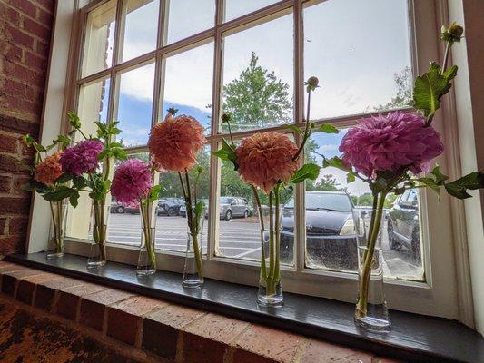 Inside. Looking out from the first dining room window from the entrance. Beautiful flowers.