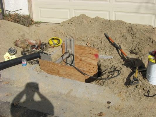 This picture shows protective shoring in a 5x5 excavated area exposing a main sewer line 9ft. deep.