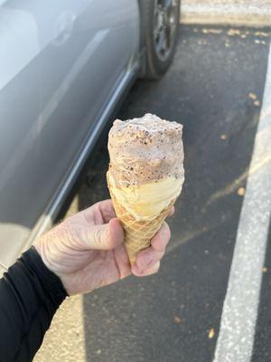 Chocolate malted crunch and salted caramel ice cream in a waffle cone.