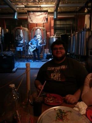 Sam enjoying some pizza and live music at the Weasel!