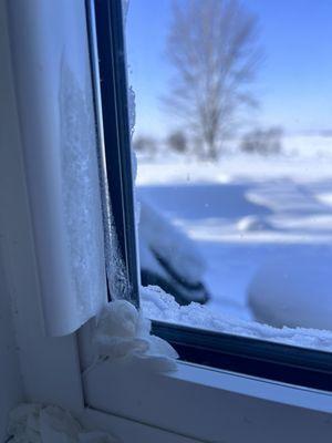 Frost inside our kitchen window plugging the drafts with paper towels