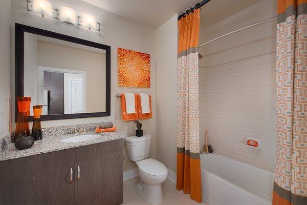 Modern bathrooms with soaking tubs, tile surround and Bluetooth showerheads in select homes