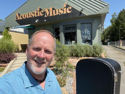 Front of the store with me holding my new Martin.