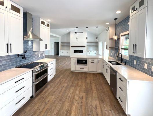 Open concept living and kitchen area. We removed a wall separating the living area and kitchen with new kitchen layout, quartz and tile.