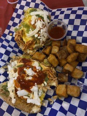 Tinga tostadas with fried egg, Mayo chipotle, queso fresco and sour cream.