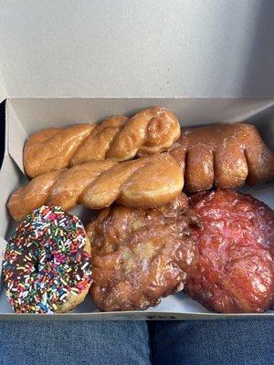 Apple fritter, Cherry fritter, bear claw, chocolate sprinkles, and two twirls