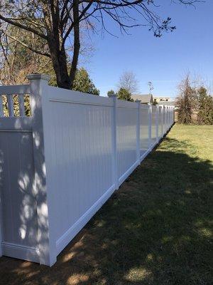 Note how straight and precise white vinyl fence installed