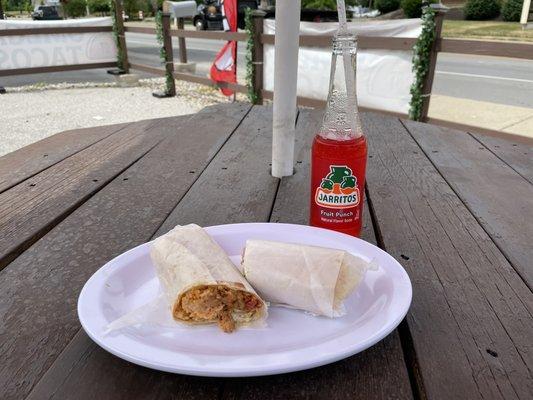 Chicken burrito with a fruit punch soda