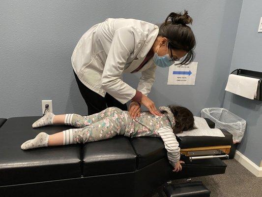 2 year old getting adjusted by Dr. Farrell.