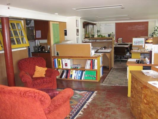 Interior desks, conference table, & partitions were constructed almost entirely from salvaged doors, windows, cork & scrap wood.