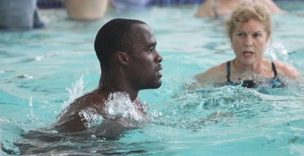 Owner Lynda Huey, helps NBA Star Emeka Okafor improve his speed and sprint performance in the pool.