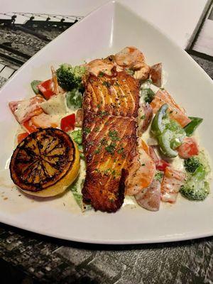 A superb Conroy's Public House Specialty...grilled Atlantic salmon and fresh vegetables in a delicious lemon dill cream sauce!