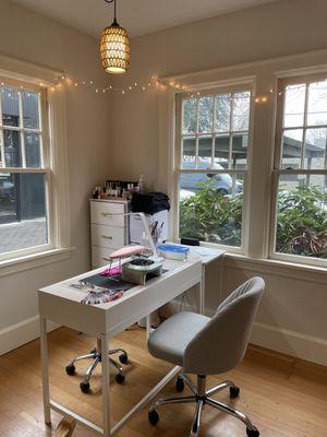 A wide shot of my nail station in the studio, showing the windows near the station and what the seating/nail area looks like.