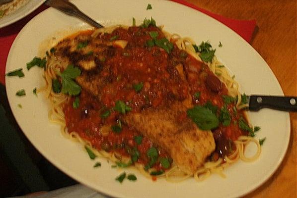 Fresh pan-fried "Haddock Napolitana" served on linguine with olives, capers, garlic, lemon, and a tomato sauce.