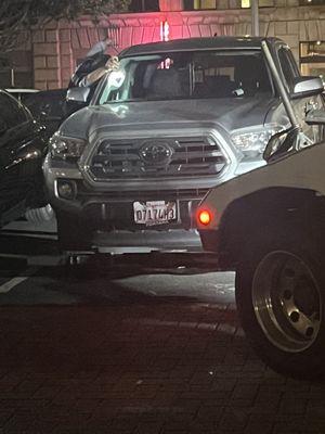 Tow truck driver unlocking customers truck to tow