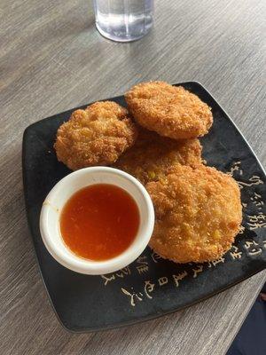 Fried corn patties with a plum sauce