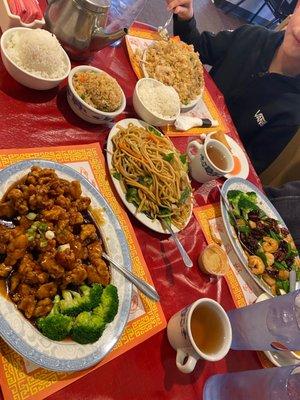 Orange chicken, chicken fried rice, veggie Lo mein, wonton soup, walnut shrimp, hot tea, spring rolls, steamed rice and fried rice.