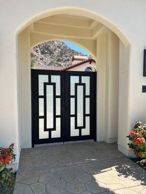 Custom Iron Courtyard gates with Frosted glass for privacy.