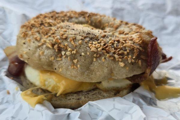 Bacon, egg, and cheese breakfast sandwich on a garlic bagel