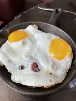 Two eggs fried over corned beef hash