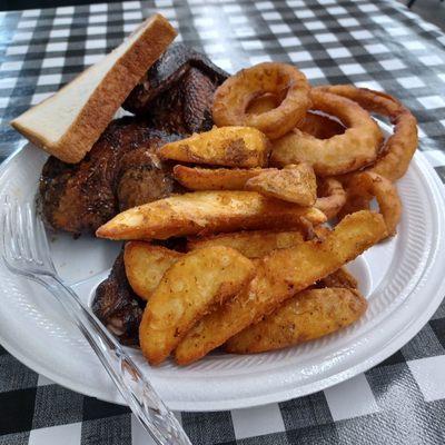 Half chicken with two sides, potato wedges and onion rings