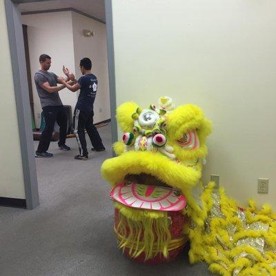 Students training at the Richmond Moy Yat Kung Fu Academy - view from the lobby with Lion Dance display.