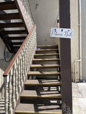 Stairs going up to the second floor, small sign