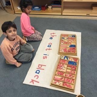 Working with my friend on the moveable alphabet