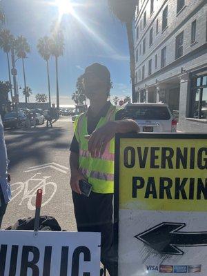 Safety Park attendant re-directing traffic away from open public lot