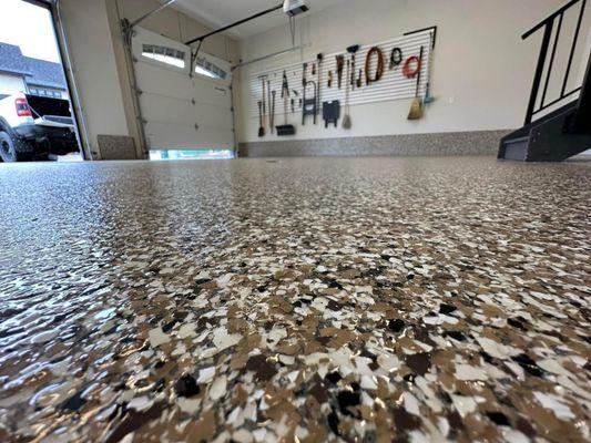 1/4 epoxy flake flooring is a great way to finish off a garage floor. It hides EVERYTHING.