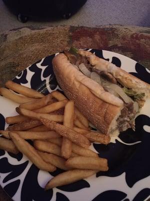 Fries and Philly Cheesesteak with American cheese, peppers, onions and mushrooms