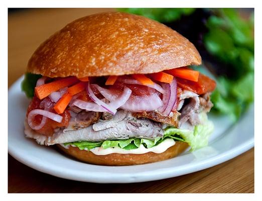 Slow roasted pork shoulder broiled tomatoes, pickled onions & carrots, bibb lettuce & habanero mayo on a toasted brioche bu