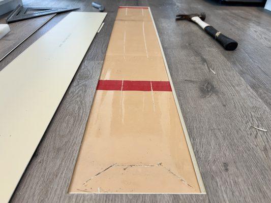 The space was prepped for the replacement plank, which was also glued down.