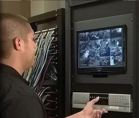 A business security video system being programmed by Fox Valley Fire & Safety's  certified technician in Oakbrook. IL.