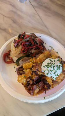 Irish Stew topped with grilled onions and pepper and loaded tots