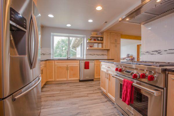 This kitchen received a complete makeover from floor to ceiling with new tile, countertops, cabinets, sink, appliances and backsplash.