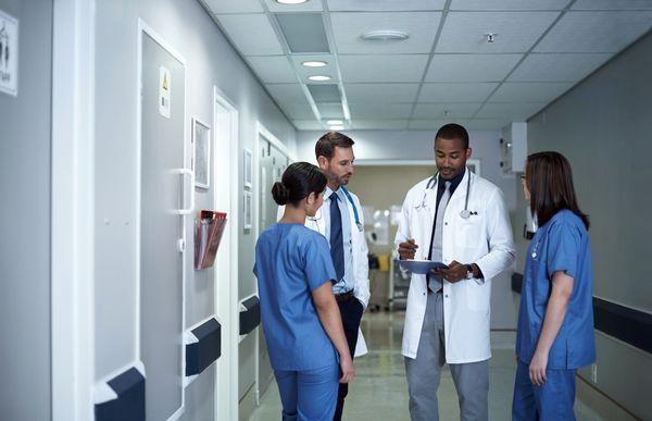 Group of doctors discussing a chart.