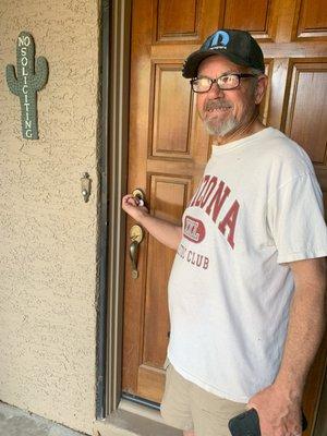 Homeowner unlocking the door to his new house.