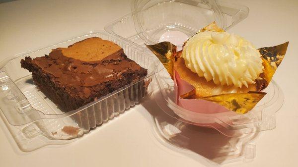 The brownie-cookie is on the left, and the White Chocolate Raspeberry cupcake is on the right.