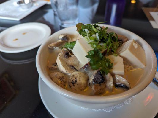 Tom kha soup bowl with tofu and noodles added.