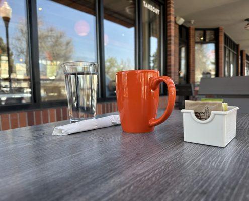 Local Coffee brew with water on the outside patio.