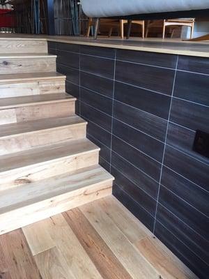 Hickory stairs with ceramic subway tile wall